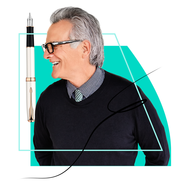 Man in glasses wearing a shirt and jumper looking at a pen