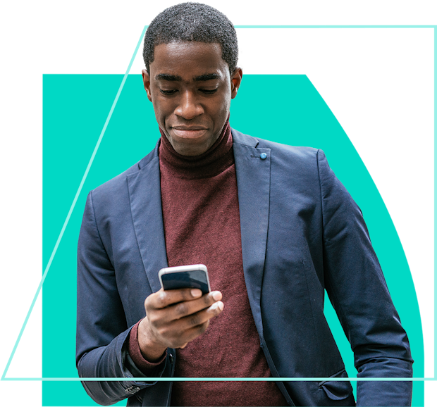 Man in a suit smiling looking at his mobile phone