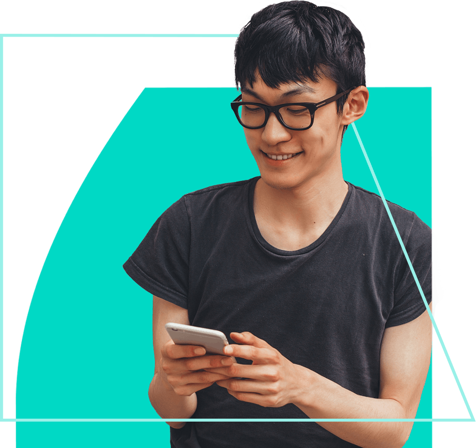 Young man wearing glasses, looking at his phone