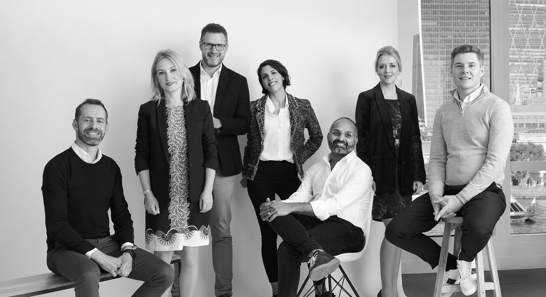 The Zopa leadership team in front of a window overlooking the city