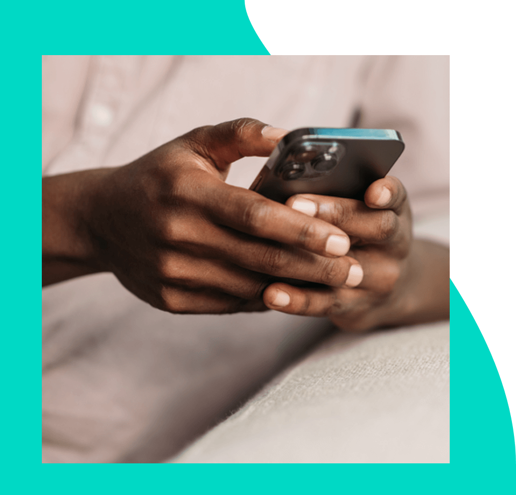 A hand holding a mobile phone displaying a credit card approval message