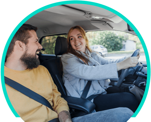 Woman and man driving a vehicle