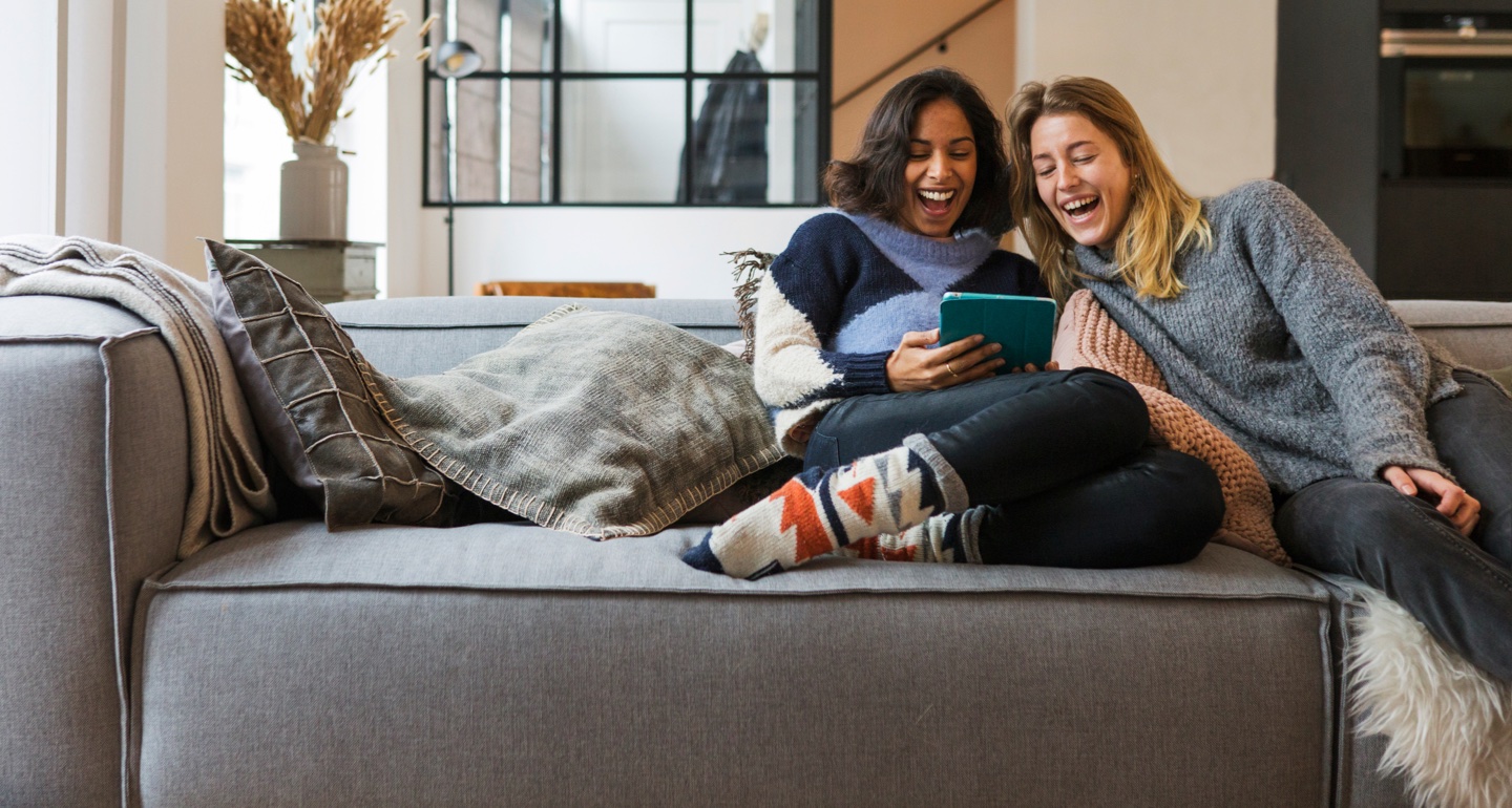 Woman smiling while sitting on a sofa