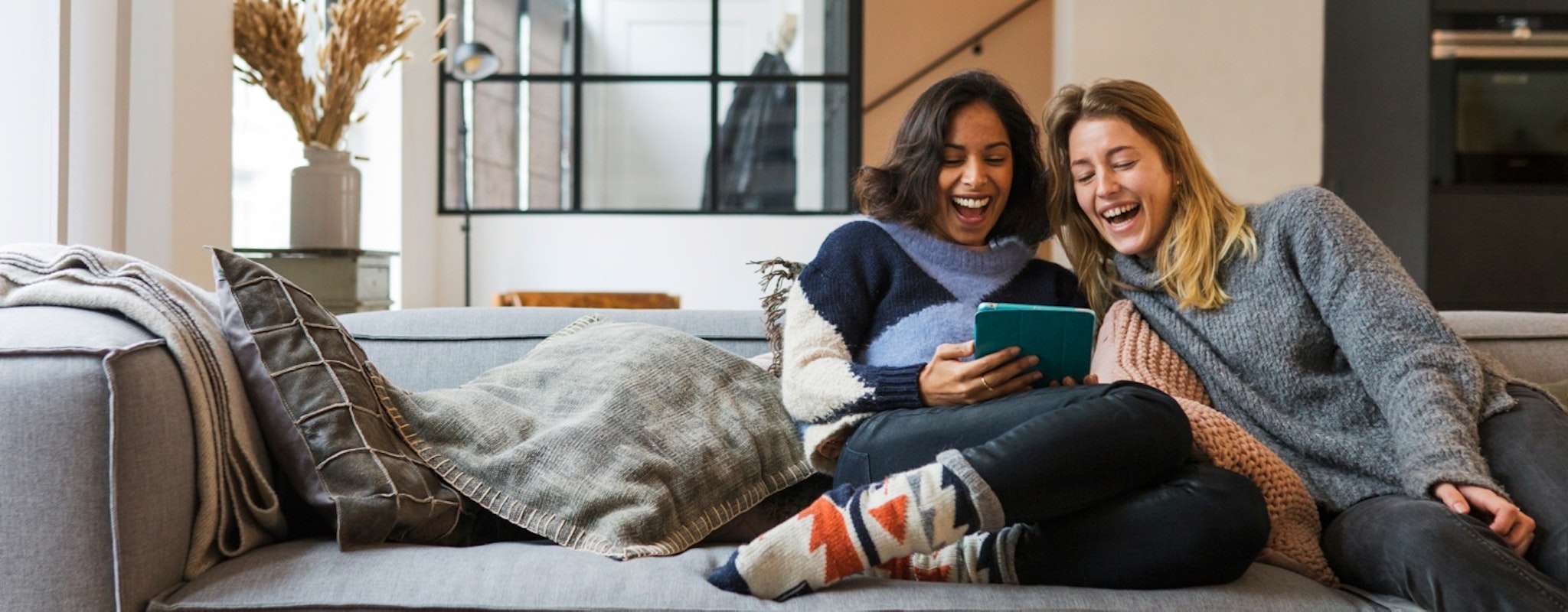 Two woman sitting in a sofa