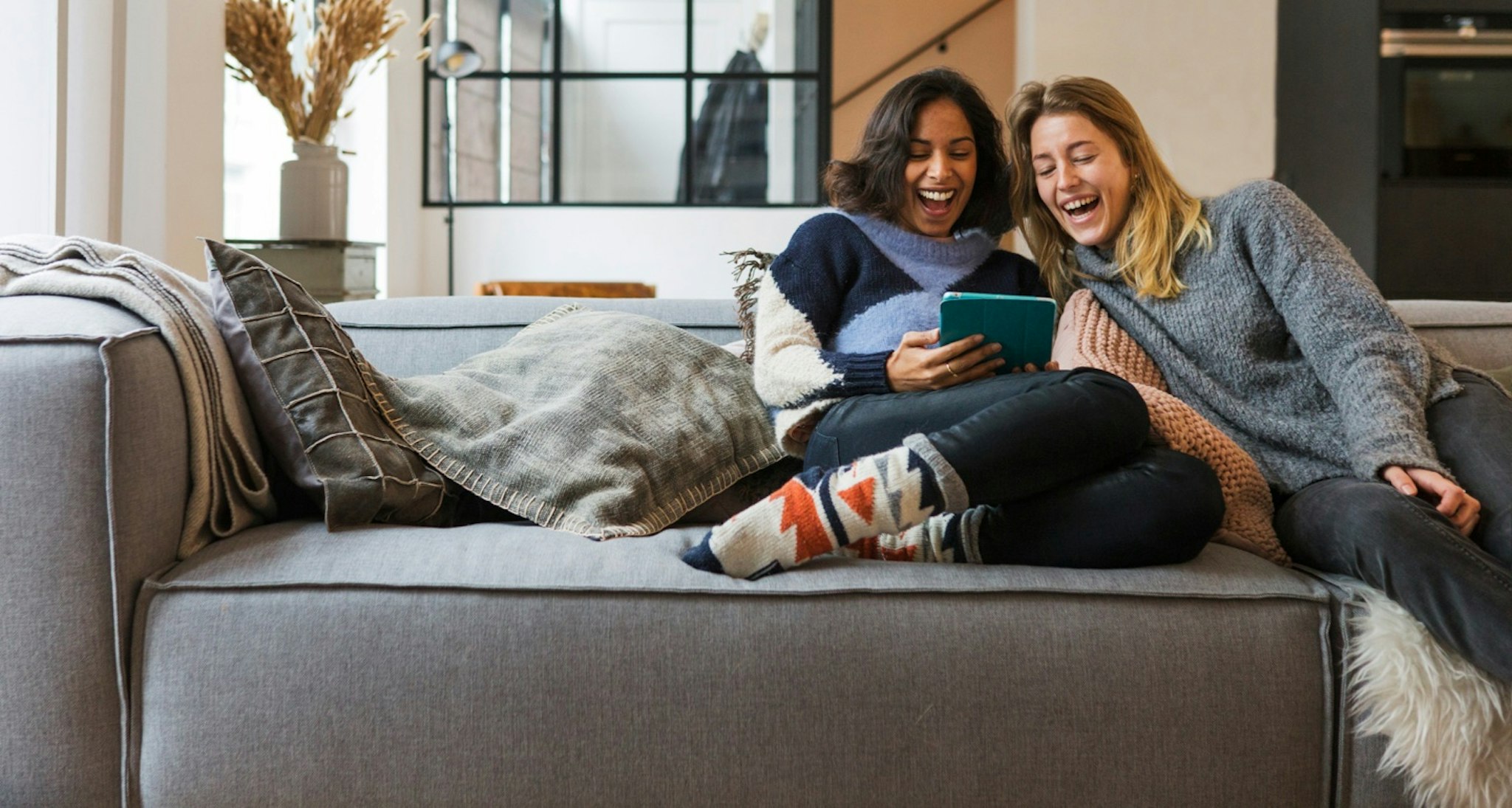 Two woman sitting in a sofa