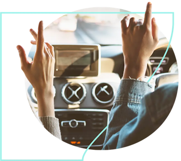 Two people in a car with their hands up