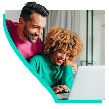 happy couple looking at computer