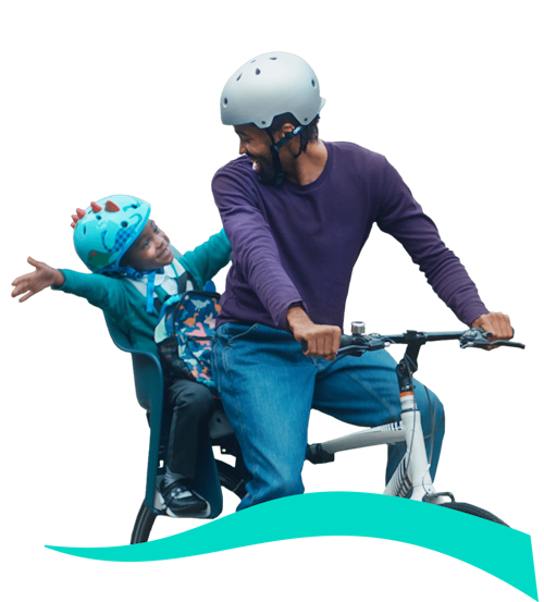 Man and Child looking at each other whilst on a bike