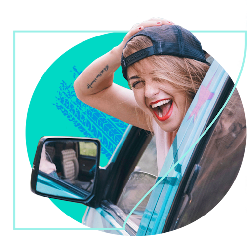 Smiling woman with head sticking out of car window
