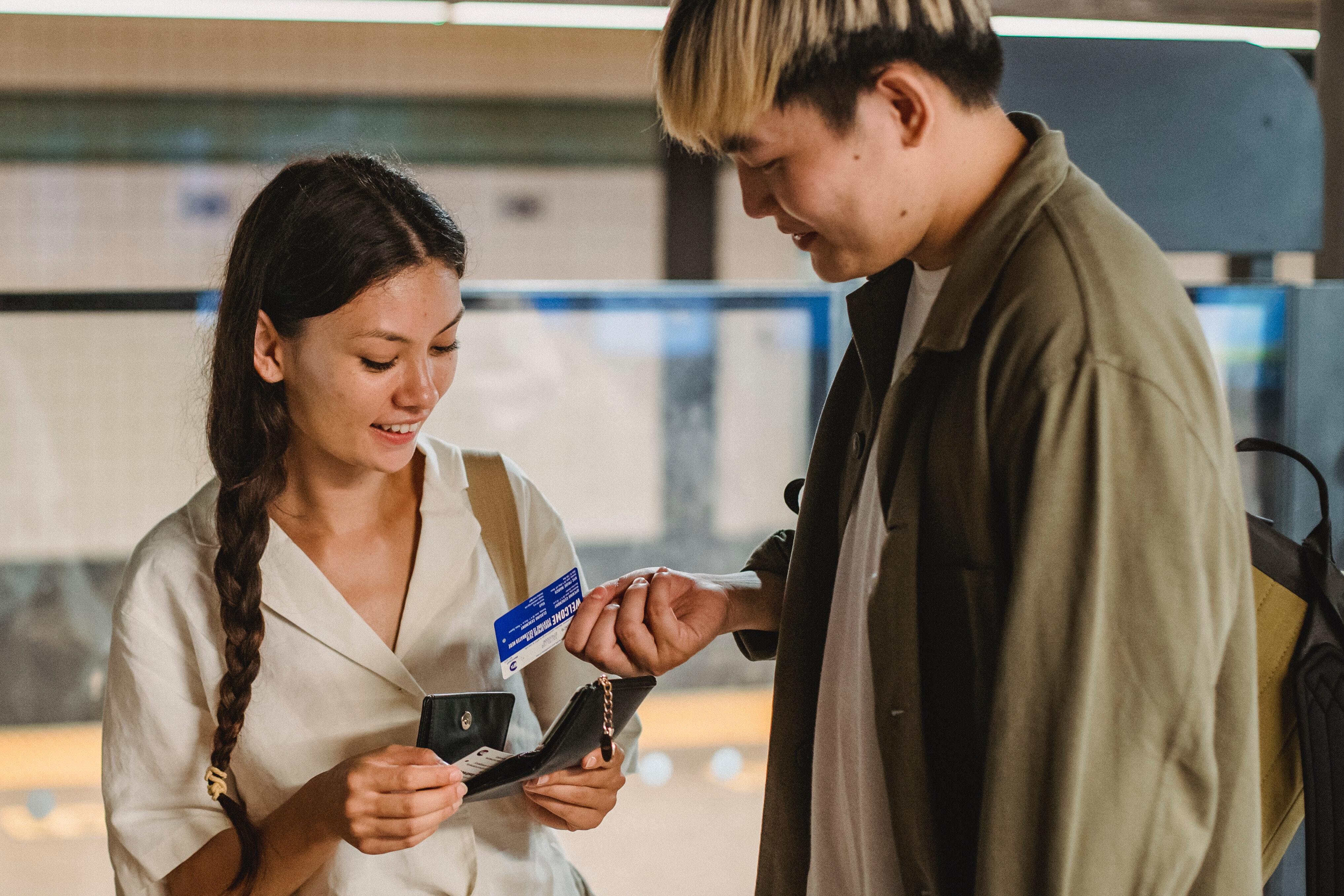 man giving card to woman