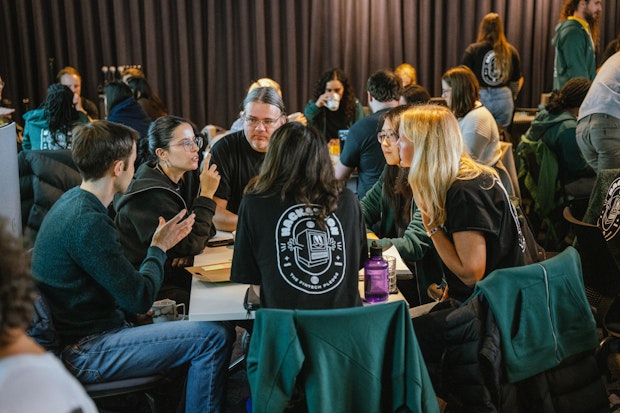One team gathers around to brainstorm Hackathon ideas