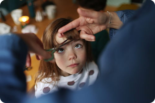 Girl having her hair cut