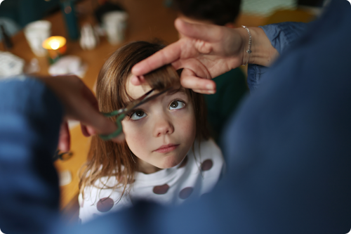 Girl having her hair cut