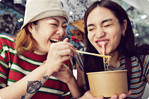 Friends eating noodles