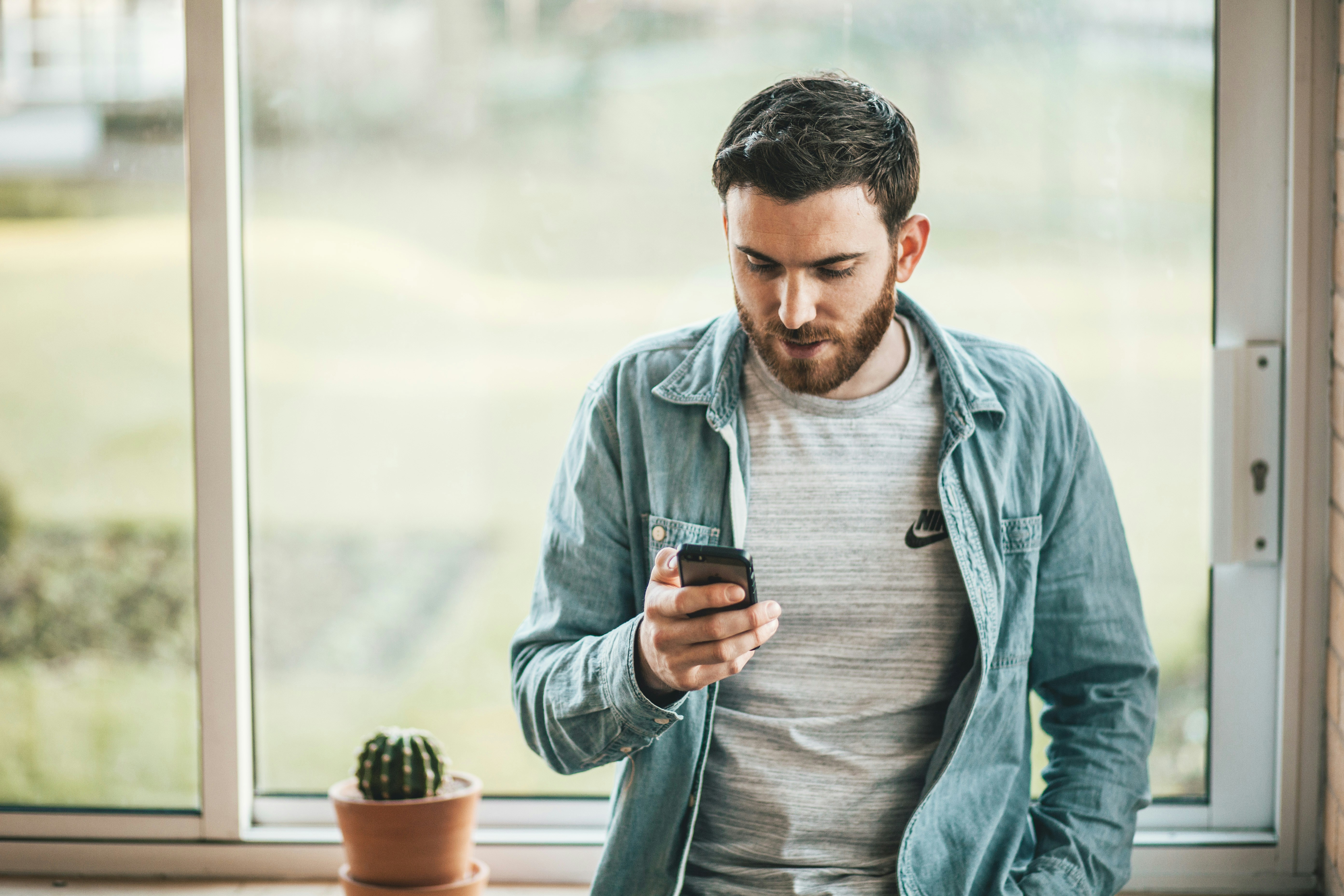 White male looks at phone with slight worried look
