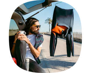 surfer having coffee in his boot