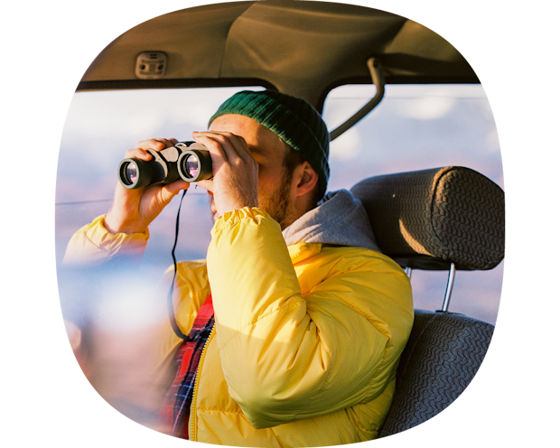 man looking through binoculars