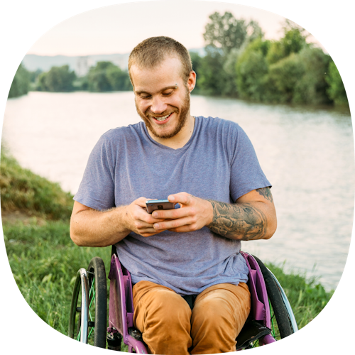 man in wheelchair and texting
