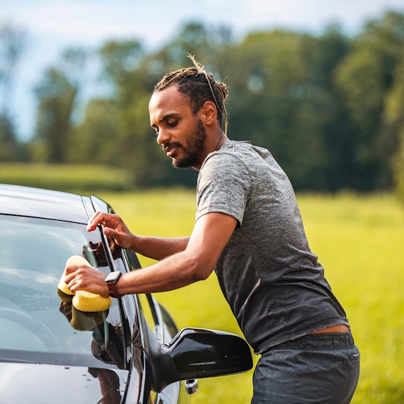 man washing car