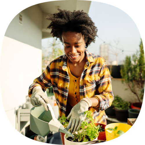 Woman watering a plant.
