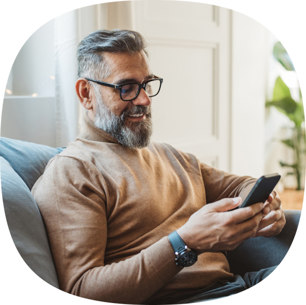 man sat on the sofa looking at his phone
