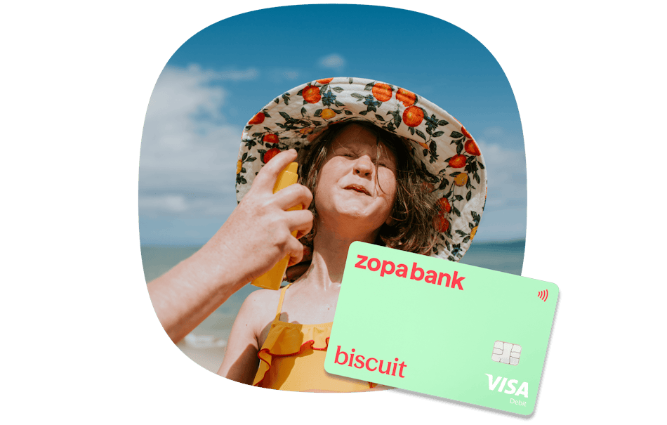 Zopa Bank_Travel Abroad_Hero_3 Girl on holiday in a hat being sprayed with sun screen
