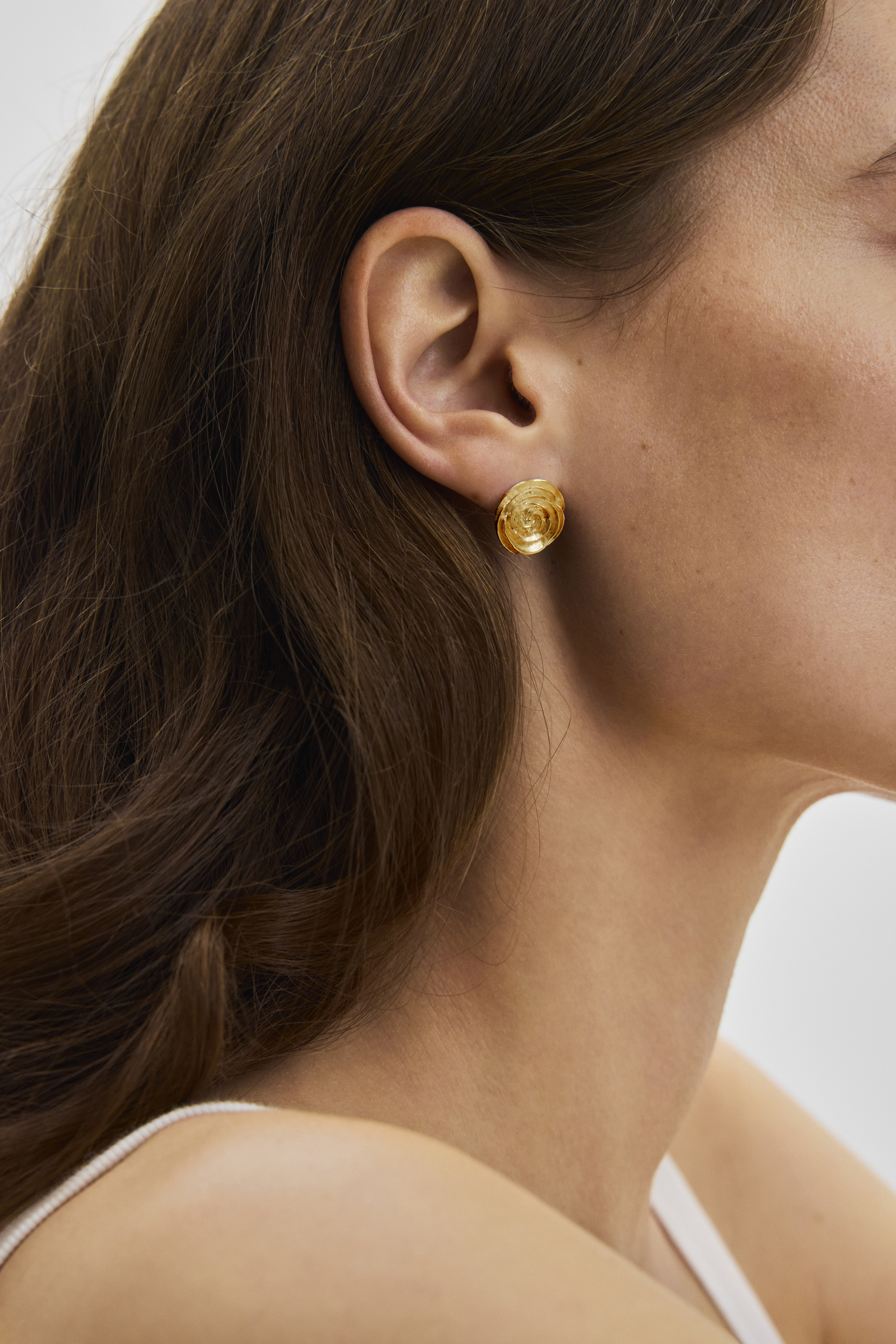 woman with gold rose ear stick