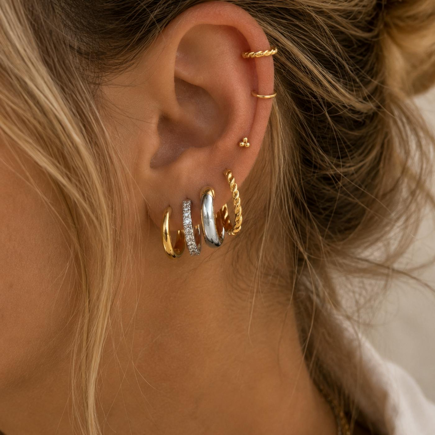 Can you mix gold and silver jewellery? Ear stack with gold and silver hoop earrings and small studs