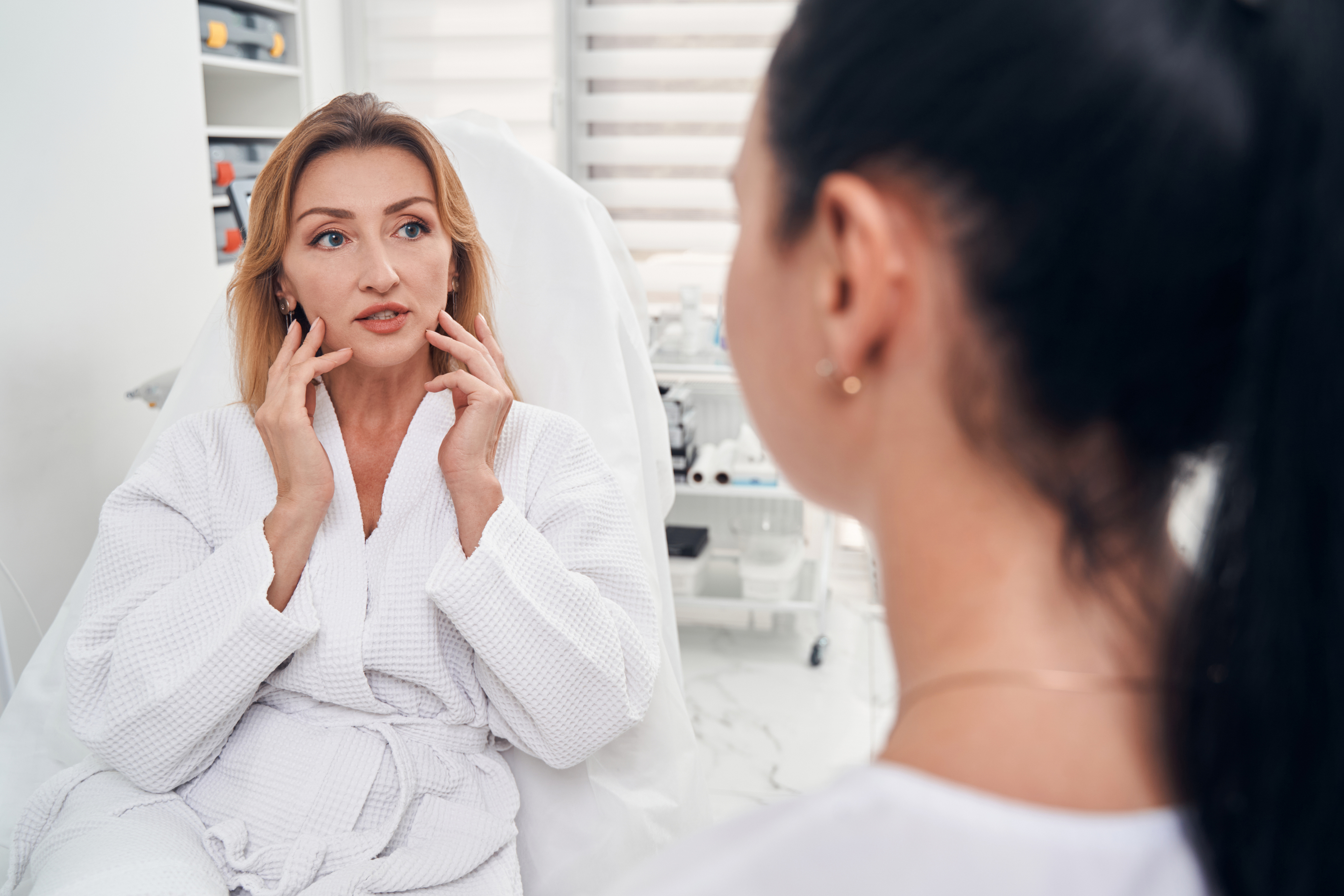 woman speaking with plastic surgeon