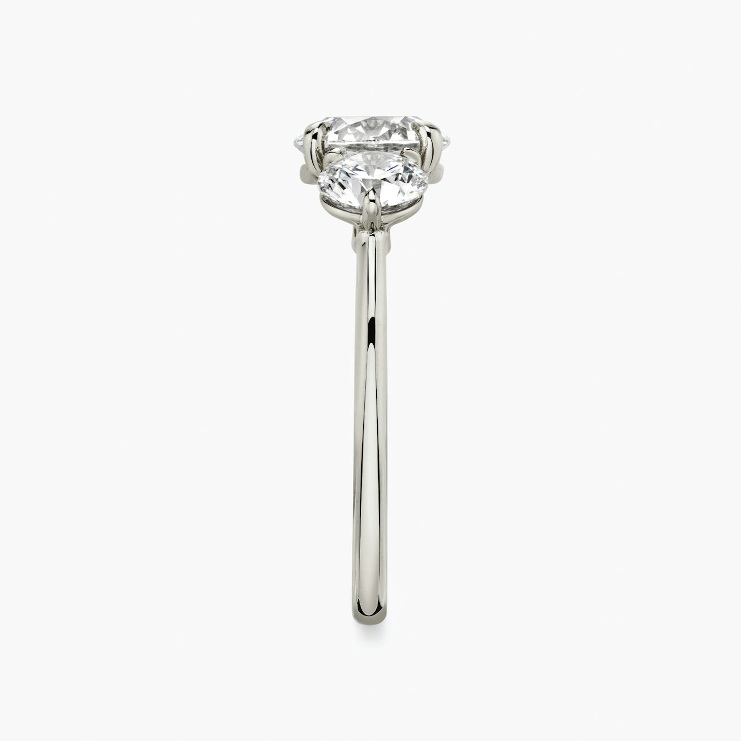The Three Stone | Round Brilliant | Platinum | Band: Plain | Carat weight: See full inventory | Side stone carat: 1/2 | Side stone shape: Round Brilliant | Diamond orientation: vertical