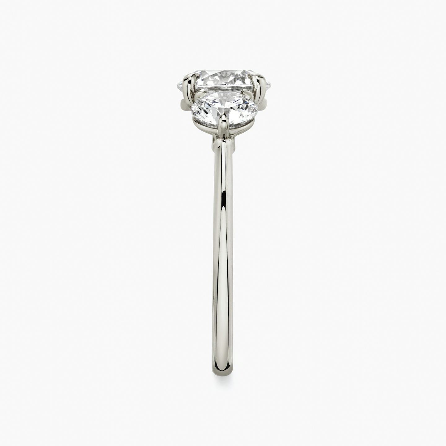 The Three Stone | Round Brilliant | Platinum | Band: Plain | Carat weight: See full inventory | Side stone carat: 1/2 | Side stone shape: Round Brilliant | Diamond orientation: vertical