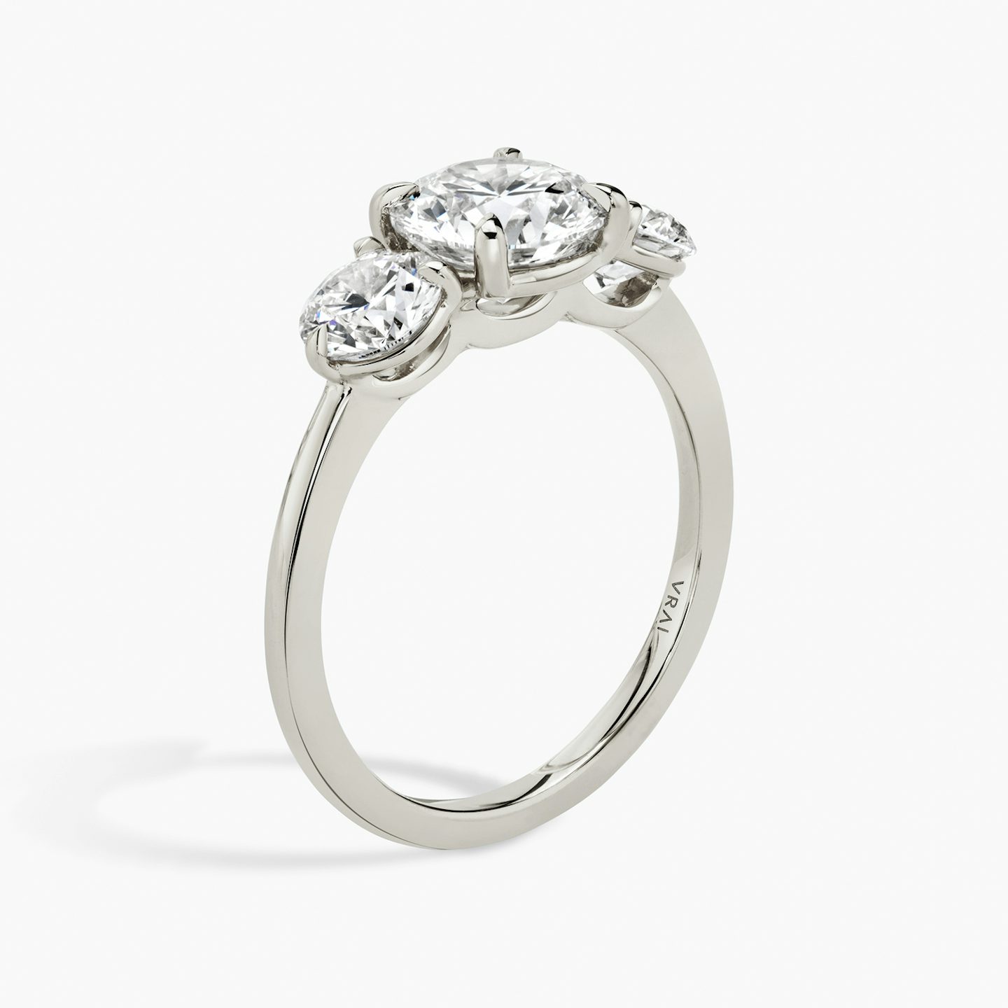 The Three Stone | Round Brilliant | 18k | 18k White Gold | Band: Plain | Carat weight: See full inventory | Side stone carat: 1/2 | Side stone shape: Round Brilliant | Diamond orientation: vertical