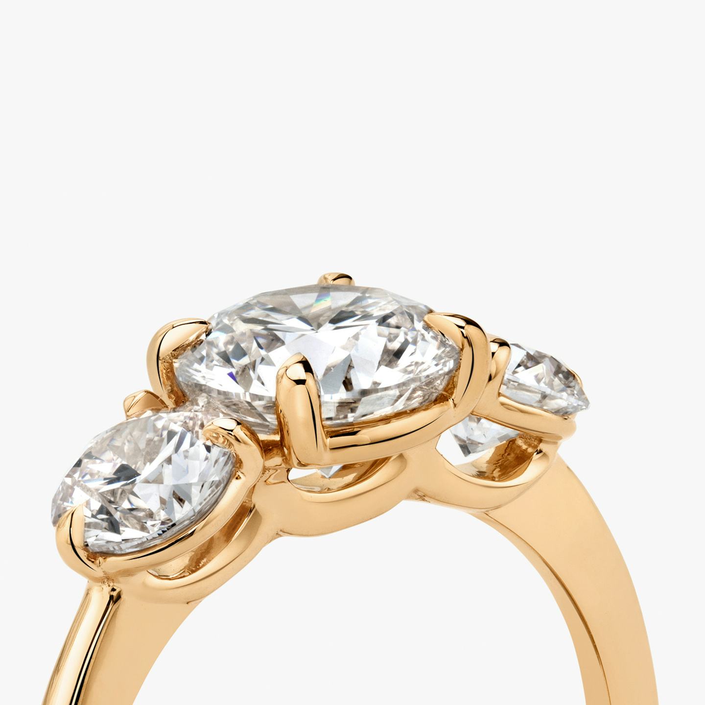 The Three Stone | Round Brilliant | 14k | 14k Rose Gold | Band: Plain | Carat weight: See full inventory | Side stone carat: 1/2 | Side stone shape: Round Brilliant | Diamond orientation: vertical