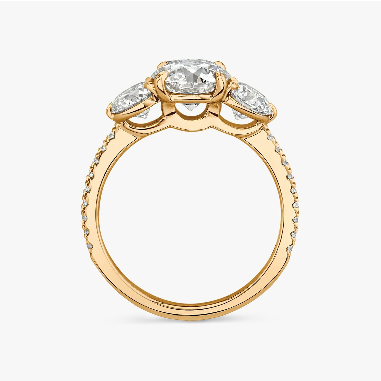 The Three Stone | Round Brilliant | 14k | 14k Rose Gold | Band: Pavé | Carat weight: See full inventory | Side stone carat: 1/2 | Side stone shape: Round Brilliant | Diamond orientation: vertical