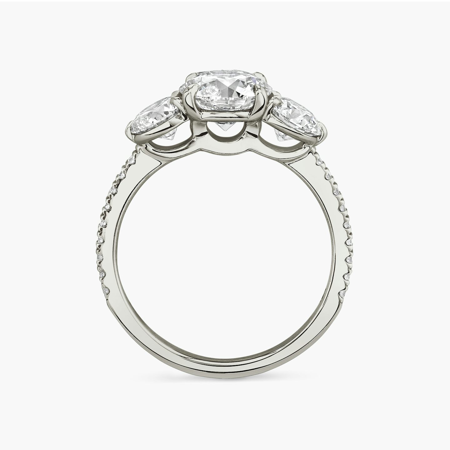The Three Stone | Round Brilliant | 18k | 18k White Gold | Band: Pavé | Carat weight: See full inventory | Side stone carat: 1/2 | Side stone shape: Round Brilliant | Diamond orientation: vertical