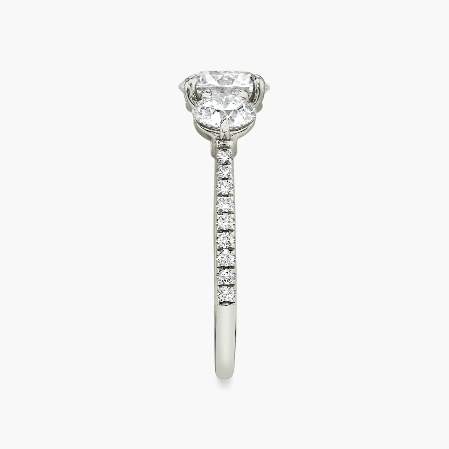 The Three Stone | Round Brilliant | Platinum | Band: Pavé | Carat weight: See full inventory | Side stone carat: 1/2 | Side stone shape: Round Brilliant | Diamond orientation: vertical