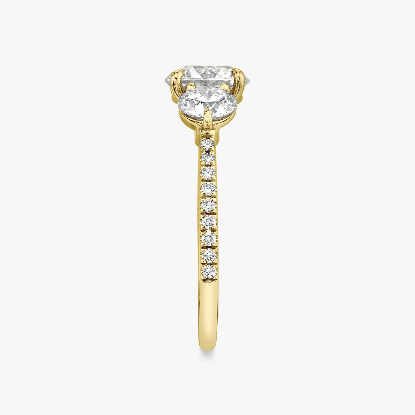 The Three Stone | Round Brilliant | 18k | 18k Yellow Gold | Band: Pavé | Carat weight: See full inventory | Side stone carat: 1/2 | Side stone shape: Round Brilliant | Diamond orientation: vertical