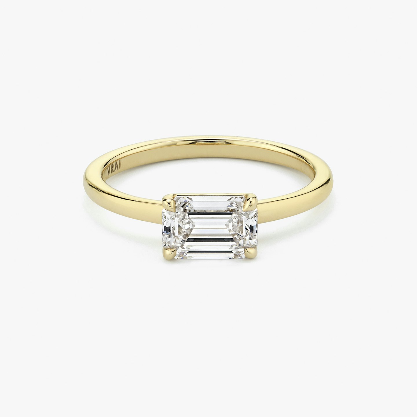 Signature prong East West emerald cut engagement ring