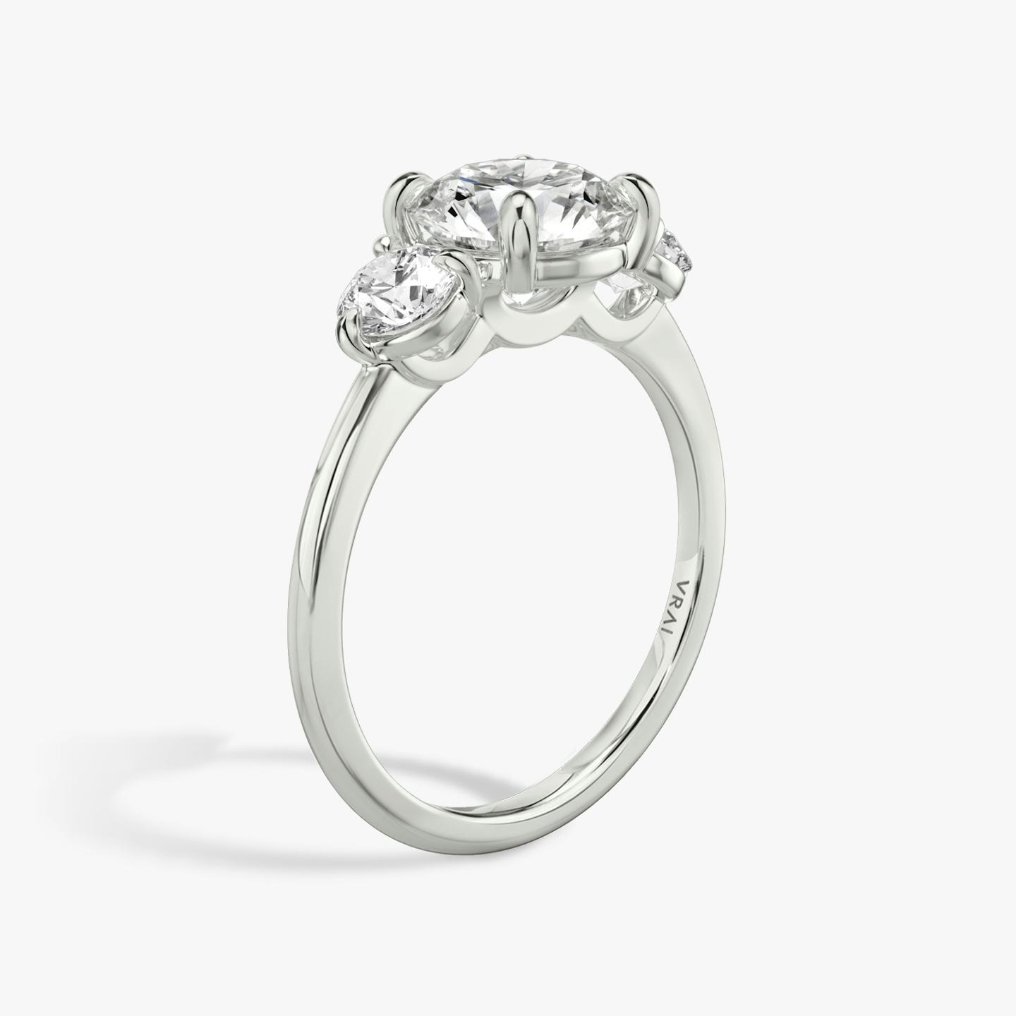 The Three Stone | Round Brilliant | 18k | 18k White Gold | Band: Plain | Carat weight: See full inventory | Side stone carat: 1/4 | Side stone shape: Round Brilliant | Diamond orientation: vertical