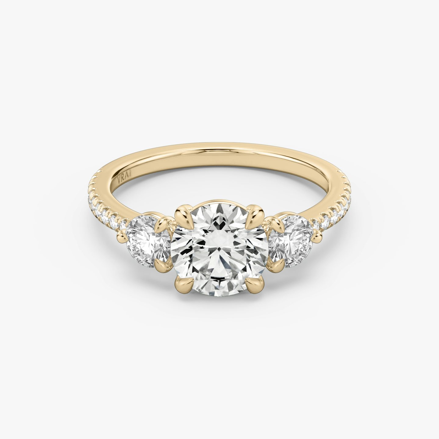The Three Stone | Round Brilliant | 14k | 14k Rose Gold | Band: Pavé | Carat weight: See full inventory | Side stone carat: 1/4 | Side stone shape: Round Brilliant | Diamond orientation: vertical