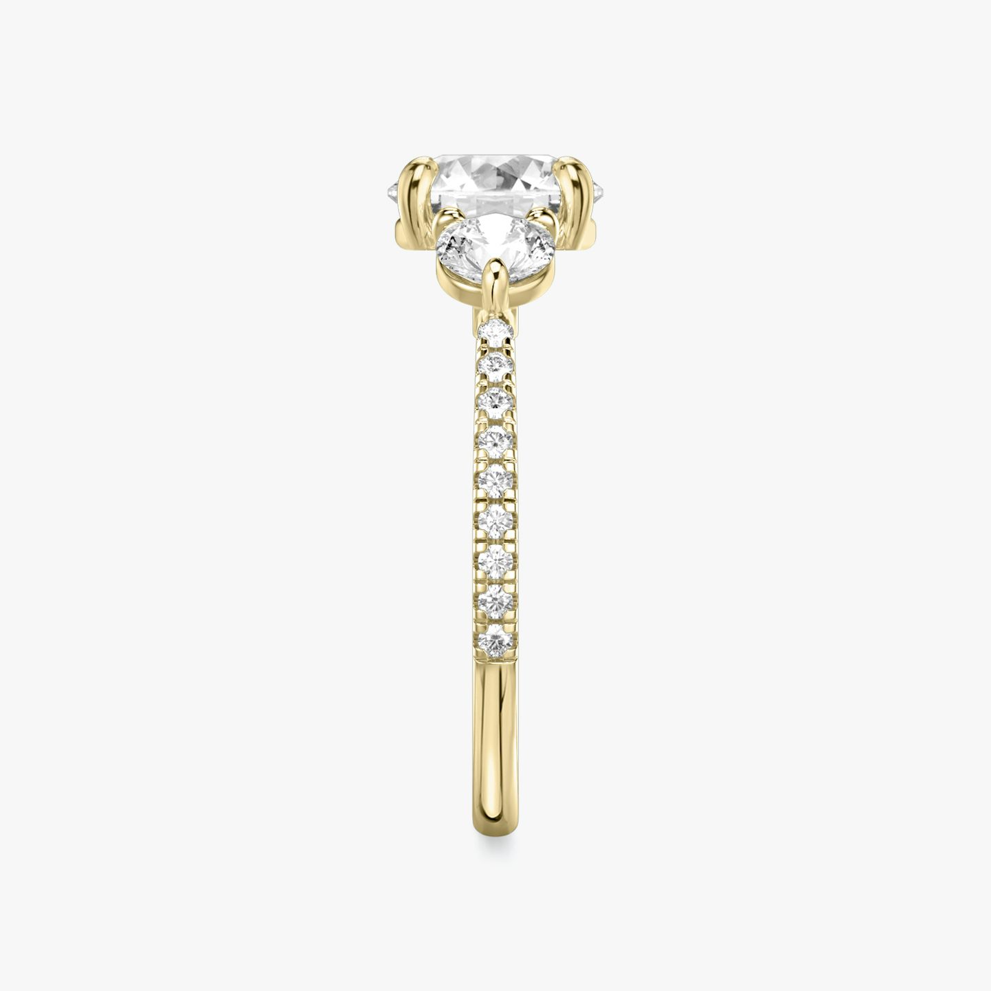 The Three Stone | Round Brilliant | 18k | 18k Yellow Gold | Band: Pavé | Carat weight: See full inventory | Side stone carat: 1/4 | Side stone shape: Round Brilliant | Diamond orientation: vertical