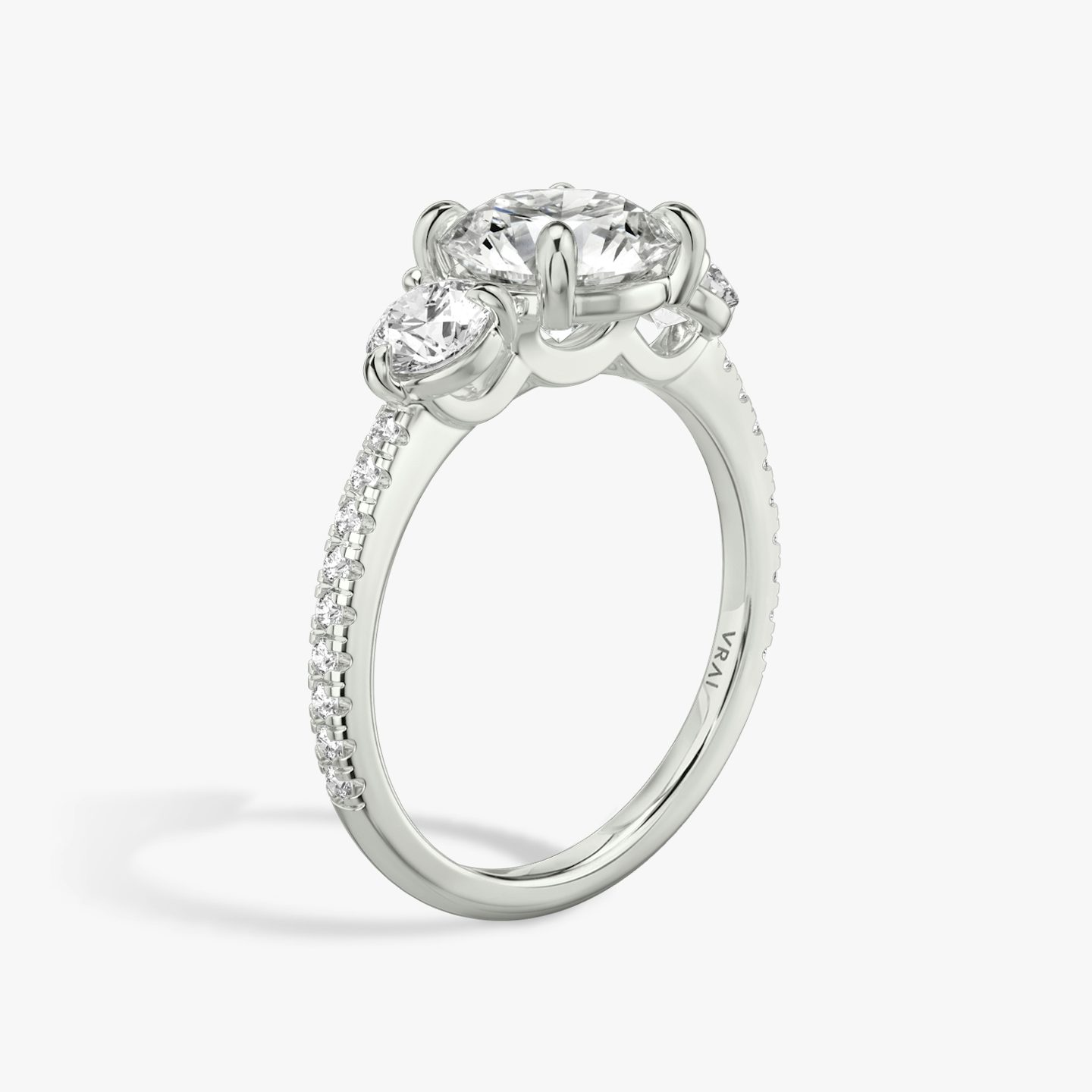 The Three Stone | Round Brilliant | 18k | 18k White Gold | Band: Pavé | Carat weight: See full inventory | Side stone carat: 1/4 | Side stone shape: Round Brilliant | Diamond orientation: vertical
