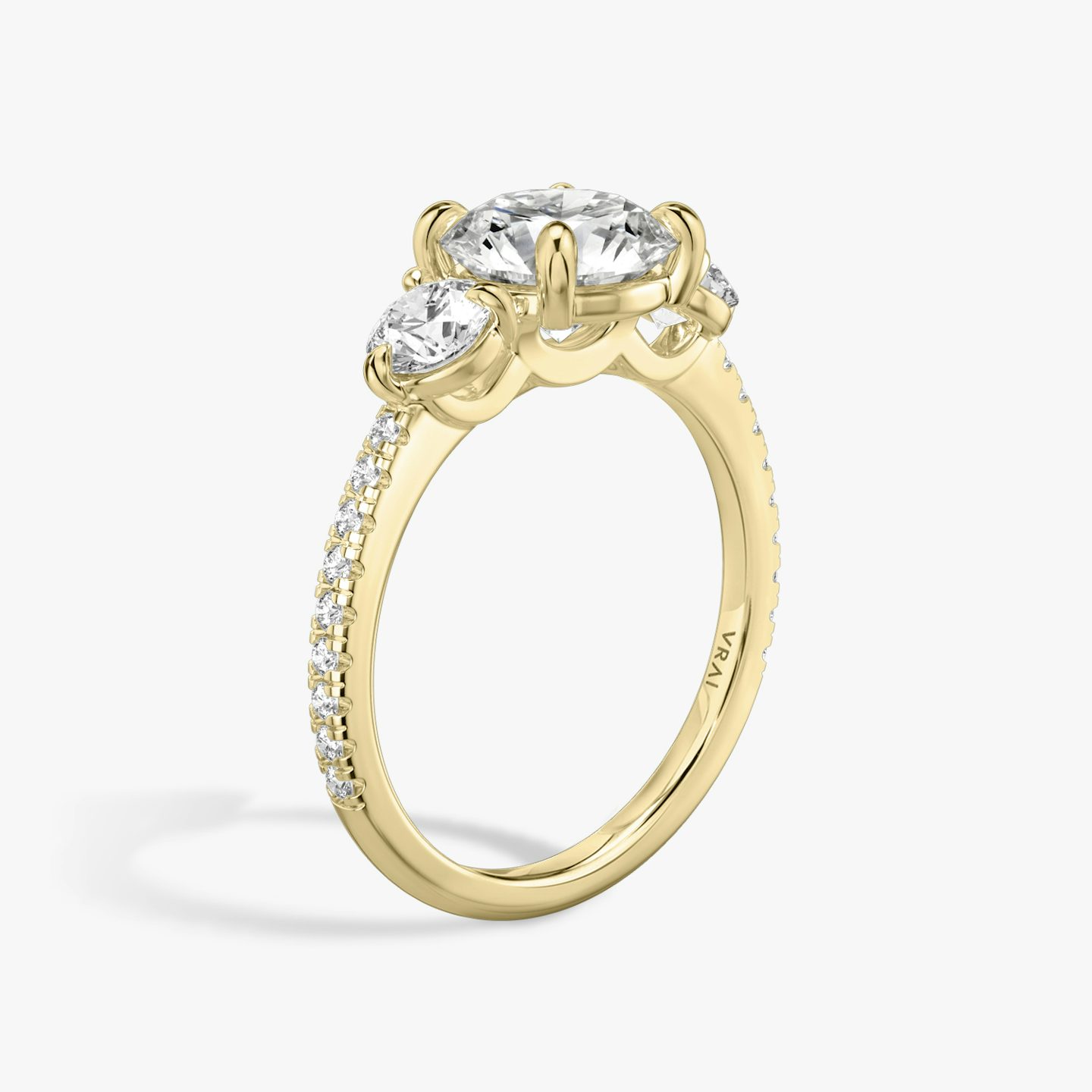 The Three Stone | Round Brilliant | 18k | 18k Yellow Gold | Band: Pavé | Carat weight: See full inventory | Side stone carat: 1/4 | Side stone shape: Round Brilliant | Diamond orientation: vertical