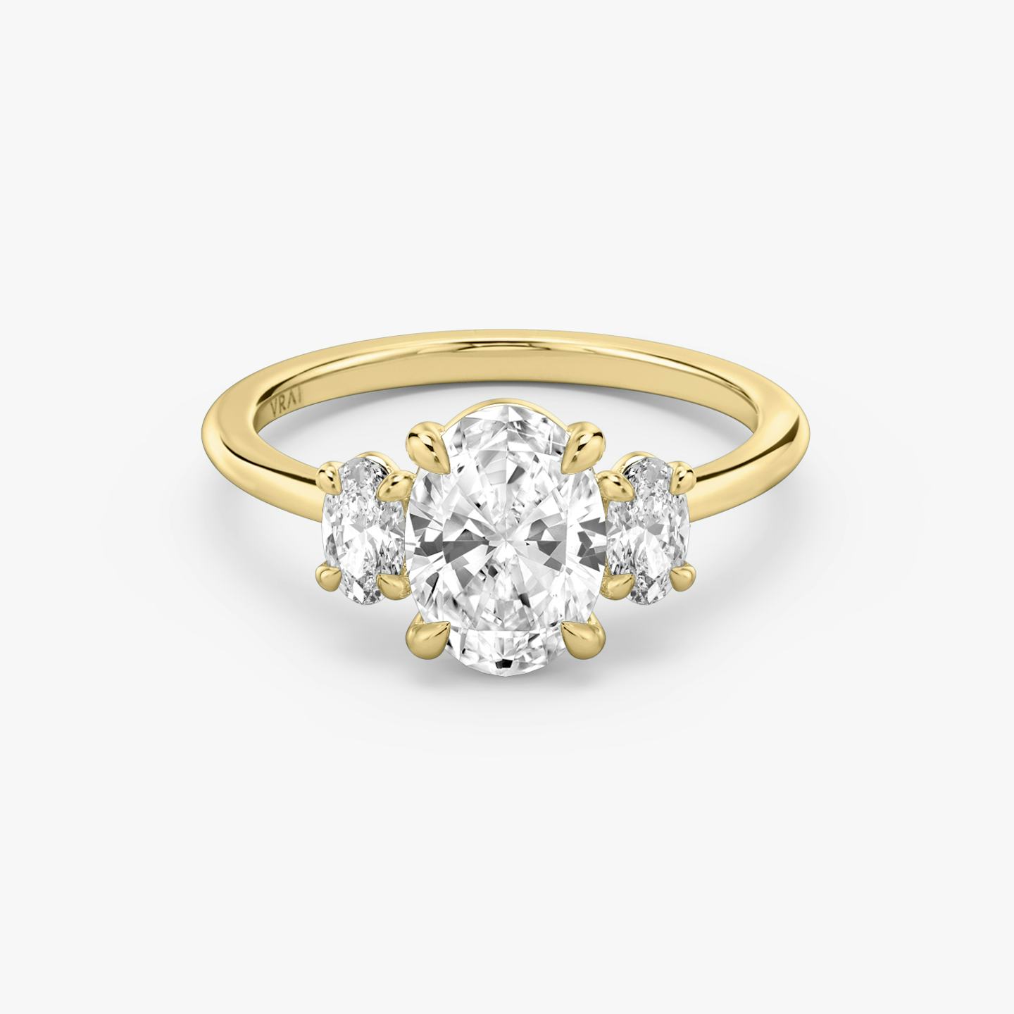 three stone oval engagement ring in yellow gold
