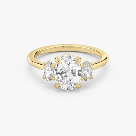 three stone oval engagement ring in yellow gold