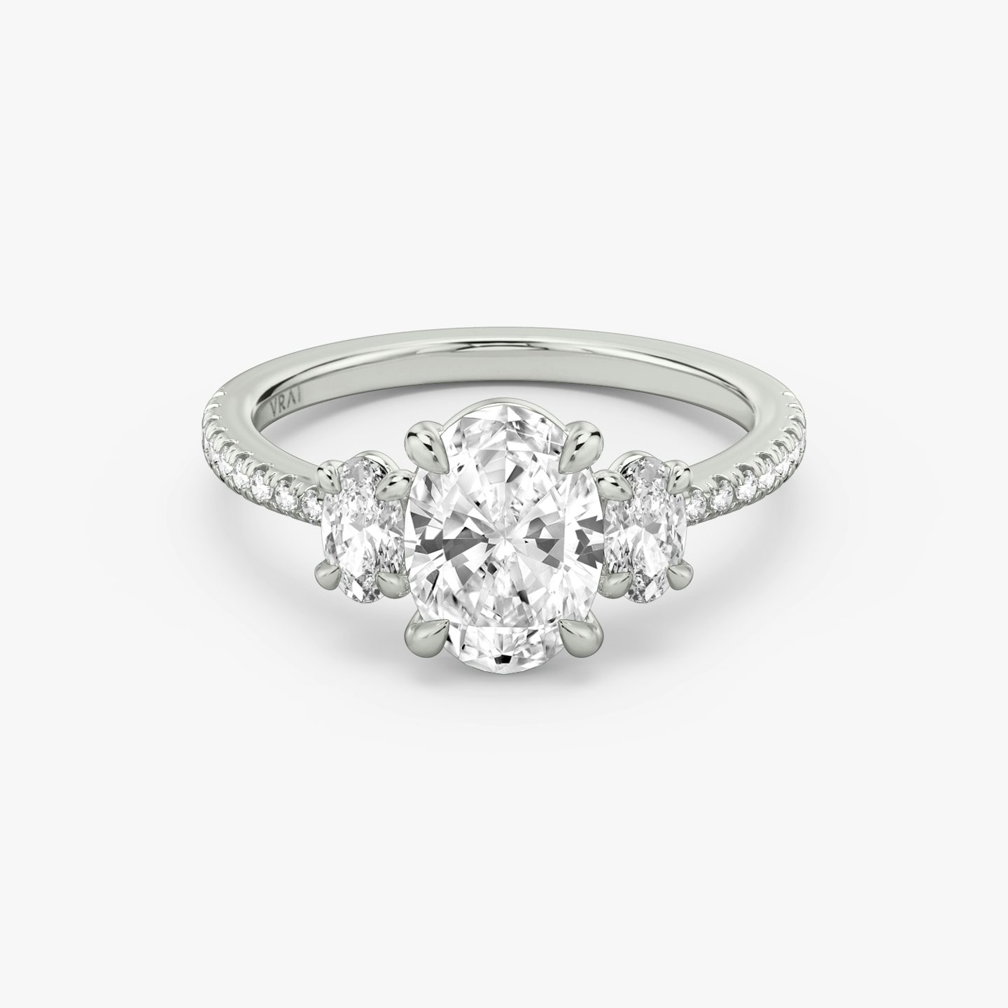 The Three Stone | Oval | Platinum | Band: Pavé | Side stone carat: 1/4 | Side stone shape: Oval | Diamond orientation: vertical | Carat weight: See full inventory