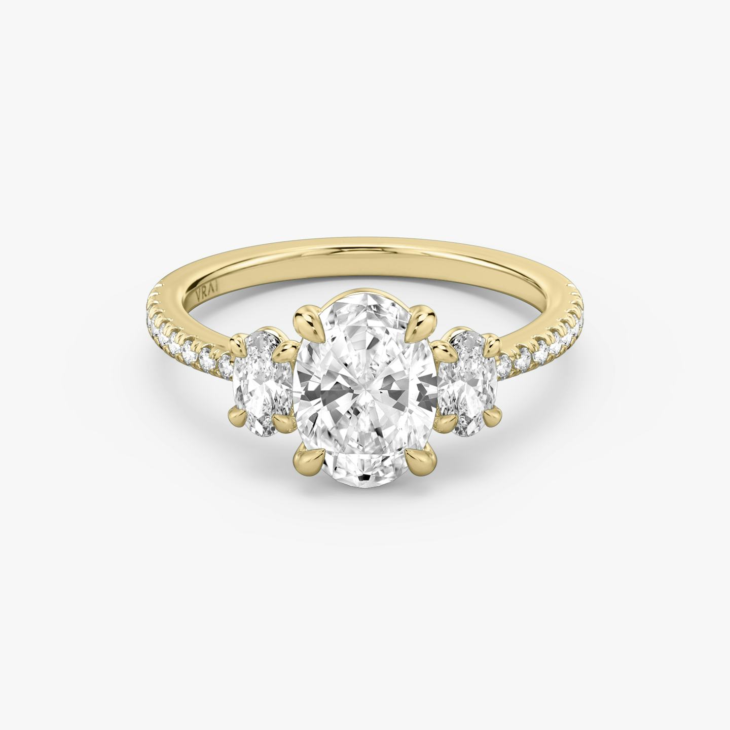 The Three Stone | Oval | 18k | 18k Yellow Gold | Band: Pavé | Side stone carat: 1/4 | Side stone shape: Oval | Diamond orientation: vertical | Carat weight: See full inventory