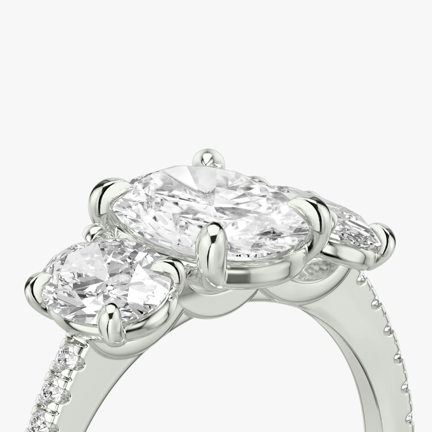 The Three Stone | Oval | 18k | 18k White Gold | Band: Pavé | Side stone carat: 1/2 | Side stone shape: Oval | Diamond orientation: vertical | Carat weight: See full inventory