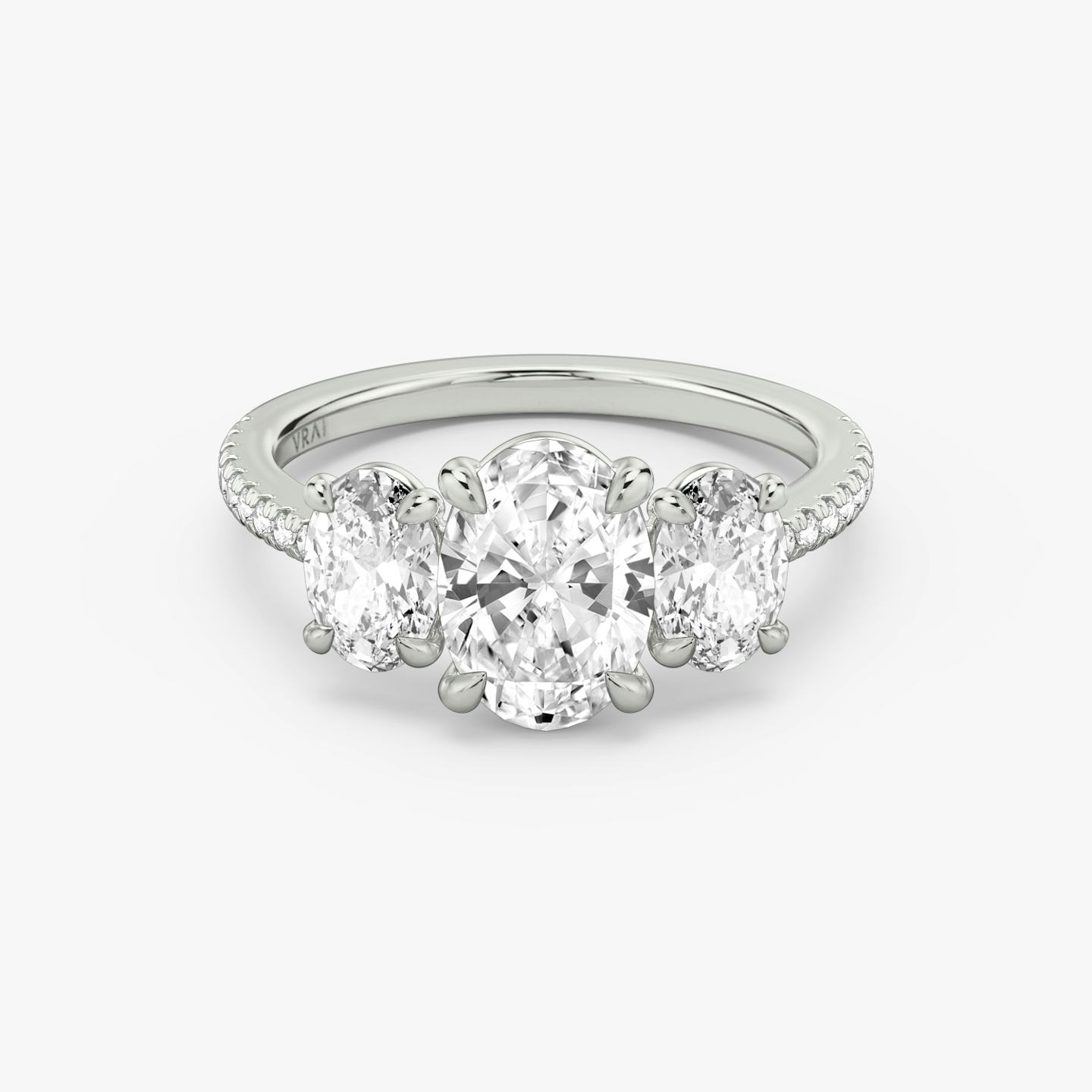The Three Stone | Oval | Platinum | Band: Pavé | Side stone carat: 1/2 | Side stone shape: Oval | Diamond orientation: vertical | Carat weight: See full inventory