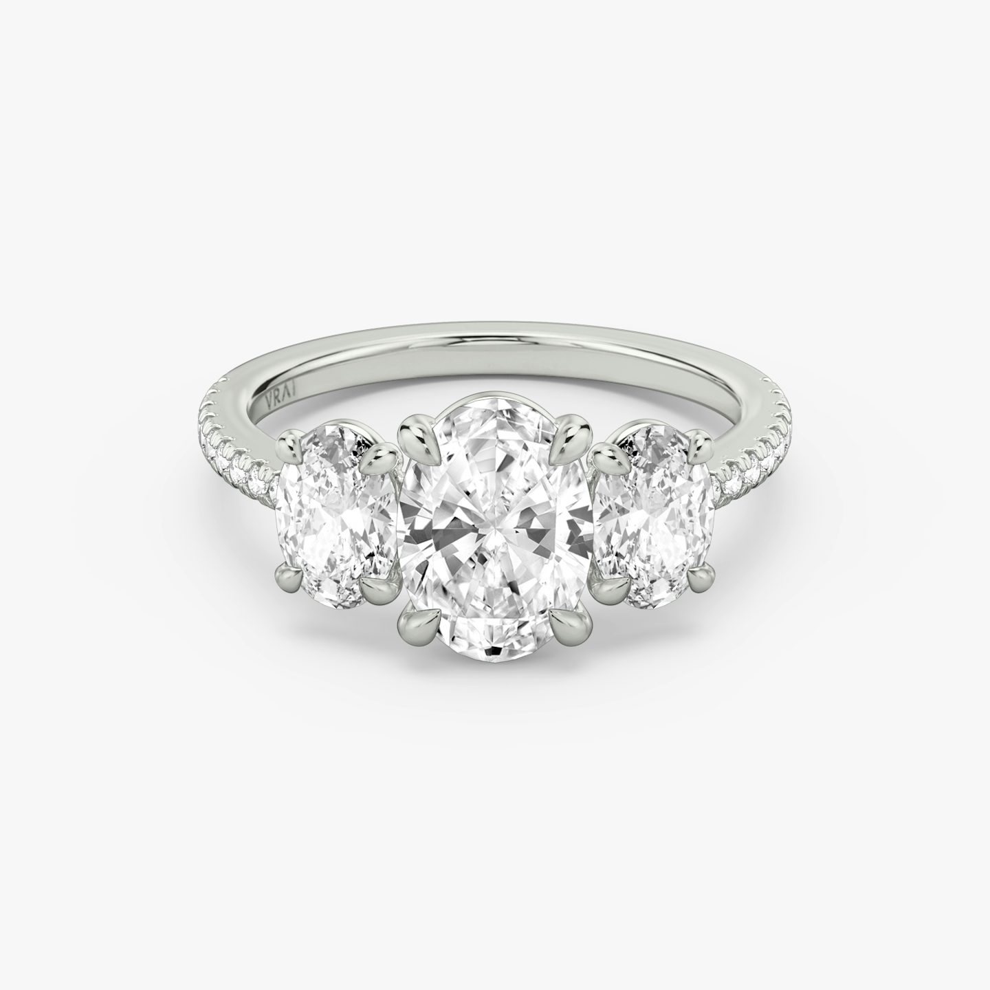 The Three Stone | Oval | 18k | 18k White Gold | Band: Pavé | Side stone carat: 1/2 | Side stone shape: Oval | Diamond orientation: vertical | Carat weight: See full inventory